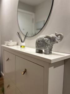 uma estátua de um elefante sentado num balcão em frente a um espelho em Apartamento Arousa Mar em Vilanova de Arousa