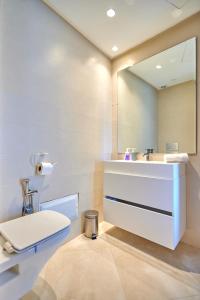 a bathroom with a white sink and a mirror at Apartment Sea View B23 - Mosquée Hassan II - By TheCasaEdition in Casablanca