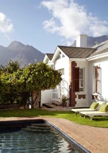 a house with a swimming pool in front of a house at InAweStays Holiday Homes in Cape Town