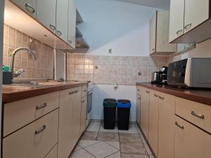 a kitchen with white cabinets and a sink at Paradise in Pula +30 photos