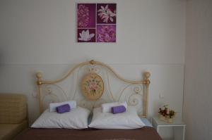 a bed with two pillows on top of it at Villa Lanca in Fažana