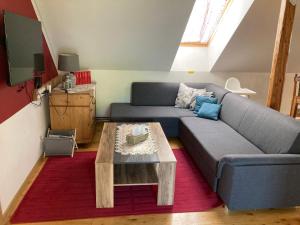 a living room with a couch and a coffee table at Apartmány Lucie in Karlovice