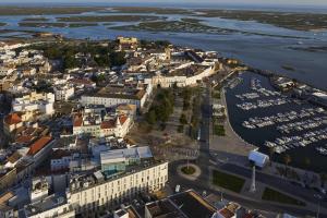 an aerial view of a city with a marina at Occidental Faro in Faro