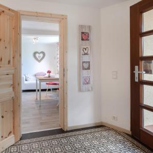 a hallway with a door leading to a dining room at Ferienwohnung Rose in Westerburg