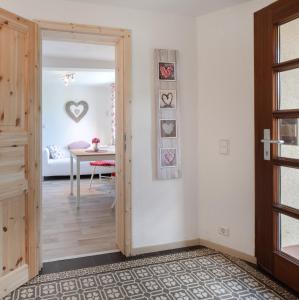 a hallway with a door leading to a dining room at 2 Bett Ferienwohnung Rose in Westerburg