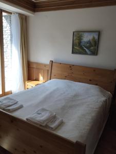 a bedroom with a bed with two towels on it at Pirin Golf - NIRVANA, Studio&SPA in Razlog