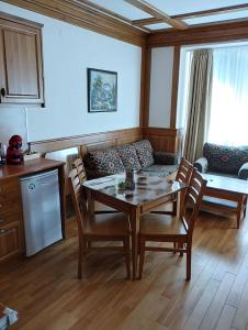 a living room with a table and chairs and a couch at Pirin Golf - NIRVANA, Studio&SPA in Razlog