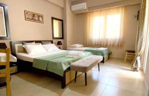 Postel nebo postele na pokoji v ubytování Aparthotel PAJA Ksamil