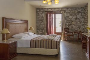 Rúm í herbergi á Itilo Traditional Hotel