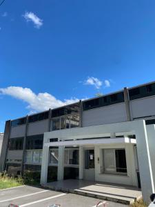 an office building with a blue sky in the background at Chez Coco - Studio à 200m de la Gare ! in Besançon