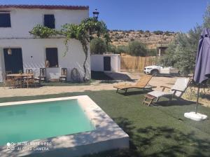 a backyard with a swimming pool and a house at Casa Rural Puente de la Vicaria by Jaxun in Yeste