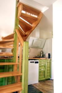 a kitchen with green cabinets and a white dishwasher at Chimera Pia Aparts in Cıralı