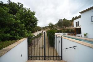a gate on the side of a house at Villa Masia Capdet in Sant Pere de Ribes