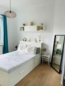 a bedroom with a large white bed with a mirror at Downtown Quiet and Peacefull Apartment in Brussels