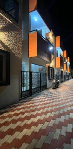 a building with a checkered floor in a hallway at RT Service Apartment Villas in Velankanni