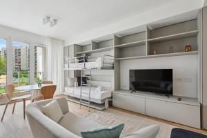a living room with a tv and a couch at Limehome Milan via Stresa in Milan
