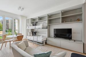 a living room with a tv and a couch at limehome Milan via Stresa in Milan