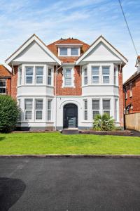 a large white house with a brick at Beach Walk Southbourne SOBO Beach Sleeps 4 in Southbourne