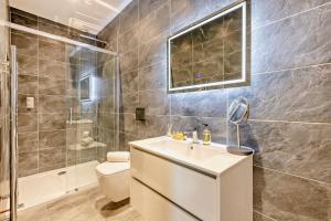 a bathroom with a sink and a toilet and a shower at Beach Walk Southbourne SOBO Beach Sleeps 4 in Southbourne