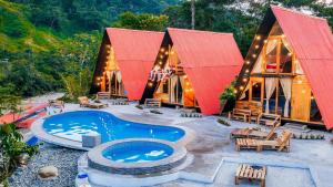 a house with a swimming pool and a resort at RioVida EcoLodge in Nueva Tarqui