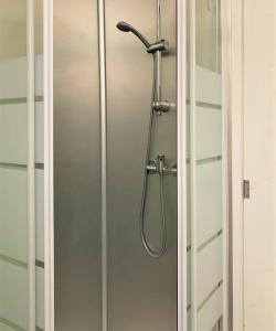 a shower in a bathroom with a glass door at SJ2D Central Baixa NEW AIR CONDITIONING Spacious and Friendly in Lisbon