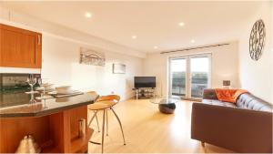 a kitchen and living room with a couch and a table at High Quays - Properties Unique in Newcastle upon Tyne