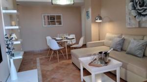 a living room with a couch and a table at La Colina Golf & Beach in Huelva