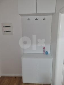 a kitchen with white cabinets and a counter top at Luxury apartment Sunny place in Mostar