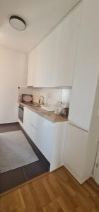 a small kitchen with white cabinets and a sink at Luxury apartment Sunny place in Mostar