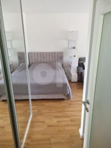 a bedroom with a bed and a wooden floor at Luxury apartment Sunny place in Mostar