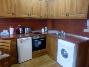 a kitchen with a washing machine and a sink at Pirin Golf - NIRVANA, Studio&SPA in Razlog +11 photos
