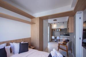 a bedroom with a bed and a living room at 360 Ascent Paulista in Sao Paulo +117 photos