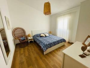 a bedroom with a bed and a wooden floor at Cantinho do Alandroal in Alandroal +27 photos