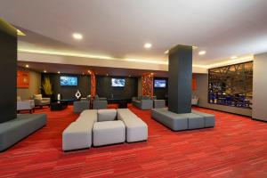 a living room with couches and chairs in a building at Courtyard by Marriott San Luis Potosi in San Luis Potosí