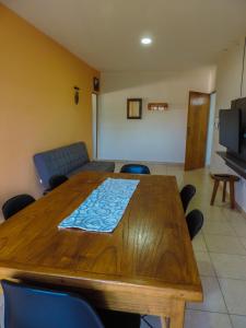 comedor con mesa de madera y sillas azules en Departamentos Daniotti en Villa del Totoral