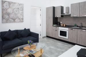 a living room with a couch and a glass table at Valletta Waterfront 2BR Flat by Arco Collection in Il-Furjana