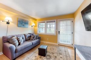 a living room with a couch and a tv at Hiawassee E302 in Asheville