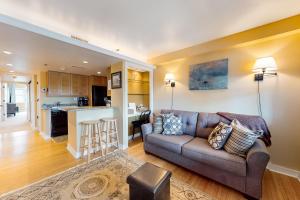 a living room with a couch and a kitchen at Hiawassee E302 in Asheville