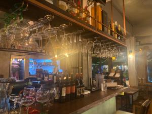 a bar with wine glasses and bottles of wine at Big Boys' Bed & Burger - Patong Beach in Patong Beach