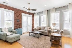 a living room with a couch and a table at Brooklyn Arts Condo in Wilmington