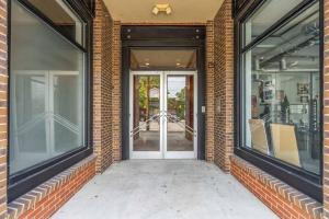 an entrance to a brick building with glass doors at Brooklyn Arts Condo in Wilmington