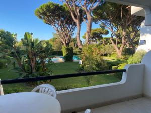 a balcony with a view of a yard with trees at Solar Dos Pinheiros in Quarteira