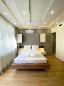 a bedroom with a large bed with white sheets at İSLAND APARTİSTANBUL in Istanbul