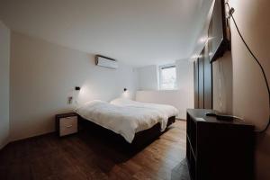 1 dormitorio con 1 cama y vestidor en Chimay : La Grande Réserve, en Chimay