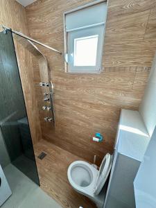 a small bathroom with a toilet and a window at Apartment Stex 2 in Podgorica