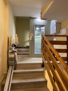 a hallway with stairs leading to a bathroom with a door at PLAZA centro in Biescas