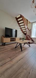 勒波泰勒的住宿－Maison clana，一间配有平面电视的客厅和楼梯