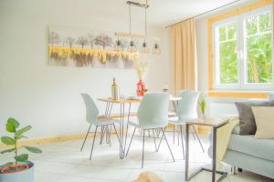 a living room with a dining room table and chairs at Wellnessoase mitten in der Wasserfallstadt Triberg in Triberg