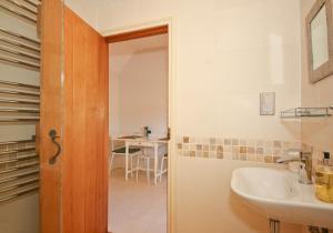 a bathroom with a sink and a mirror and a table at The Lavendrye in Wadhurst