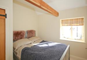 a bedroom with a bed and a window at The Lavendrye in Wadhurst